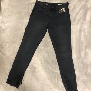 Dark wash mid rise skinny fringe jeans